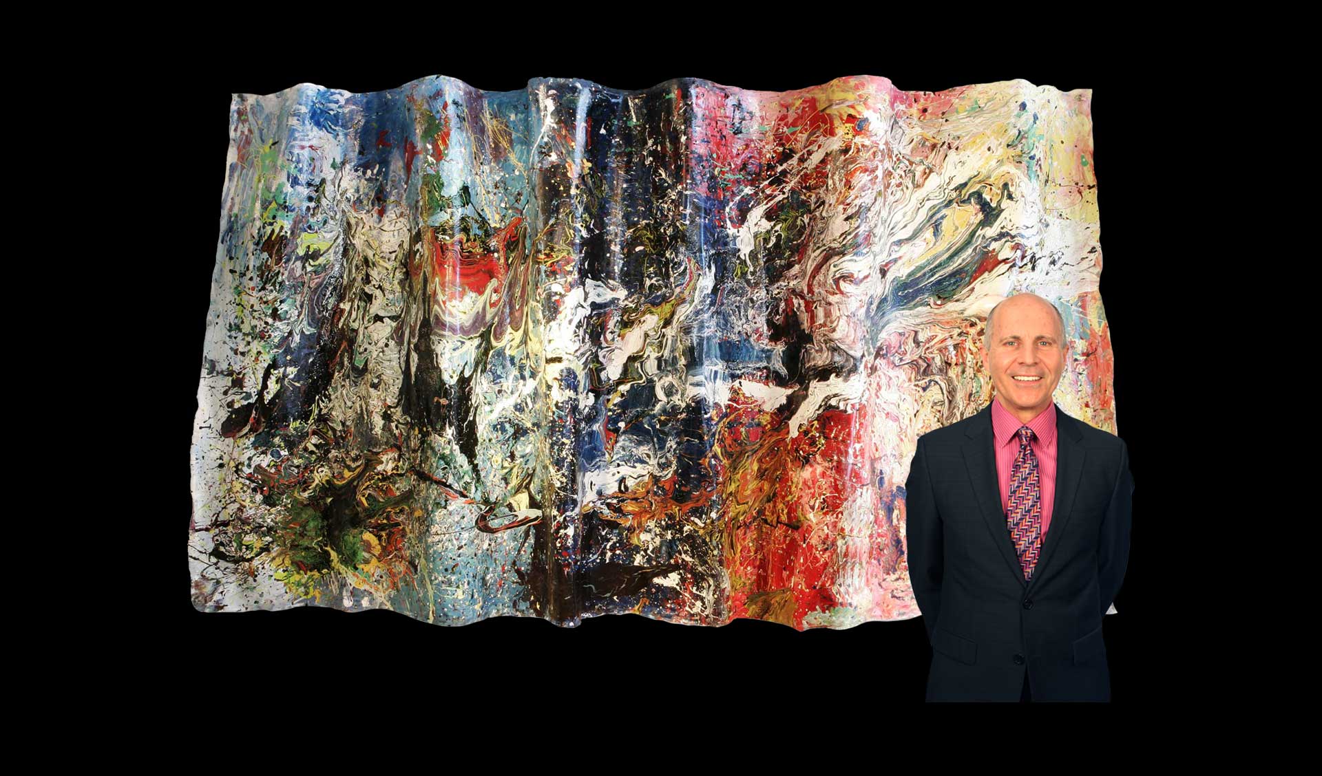 Toronto artist, Dan Couvrette standing in front of painting